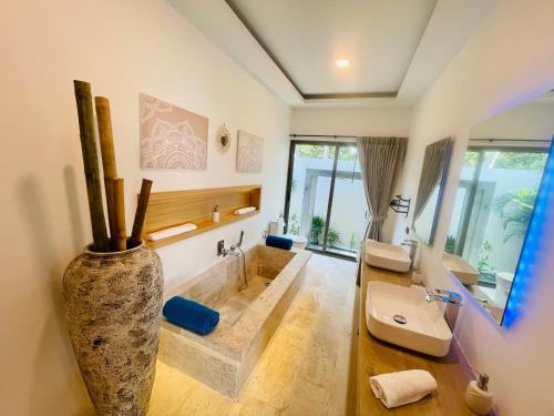 a bathroom with two sinks and a large vase at Yuka residence in Koh Samui