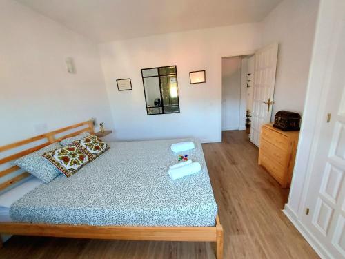 a bedroom with a bed and a dresser and a mirror at MarSolRosas in Hospitalet de l'Infant