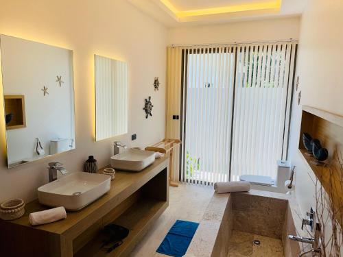 a bathroom with two sinks and a large mirror at Yuka residence in Koh Samui 