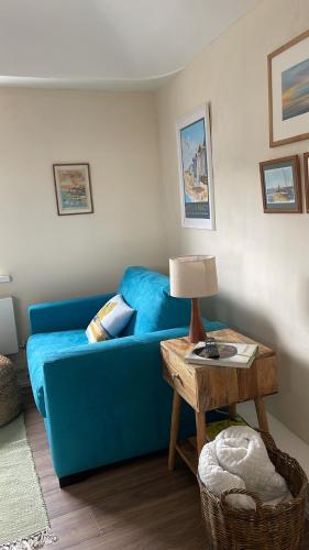 a living room with a blue couch and a table at Loft in Bungay in Bungay