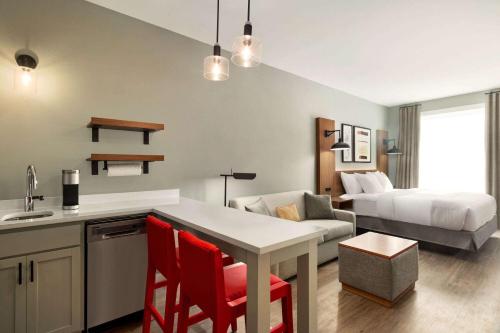 a kitchen and living room with a bed and a table at Hawthorn Extended Stay by Wyndham Mount Laurel Moorestown in Mount Laurel