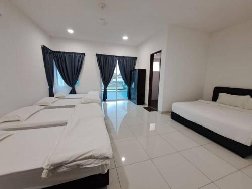 a bedroom with two beds and a window at Villa Chee in Sekincan