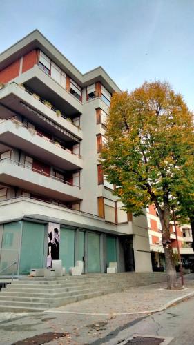 a building with a tree in front of it at APPARTAMENTO LA SPIAGGETTA in Foligno