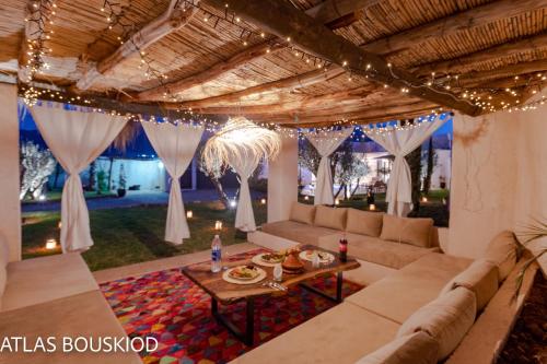 a living room with a couch and a table at ATLAS BOUSKIOD in Tizfrit