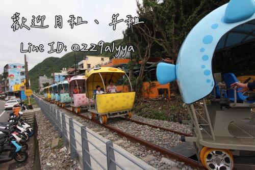 a toy train on a track with people on it at Sea Keelung in Keelung