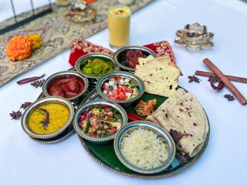 a plate of food with different types of food on a table at Taj 51 Buckingham Gate Suites and Residences in London