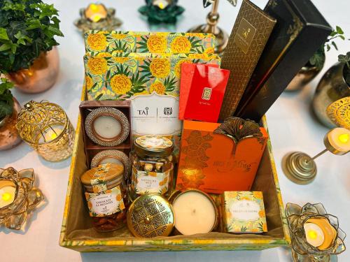a tray filled with gifts and jars on a table at Taj 51 Buckingham Gate Suites and Residences in London
