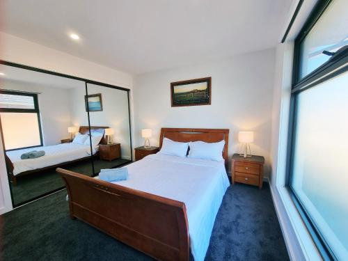 阳光海岸Brand new house - Mordern home and great location的一间卧室，配有一张大床和一扇大窗户。