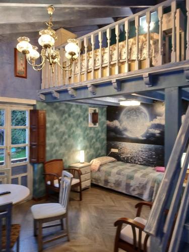 a bedroom with a bunk bed and a staircase at PENSION ALFOZ de RONDIELLA in Piñeres