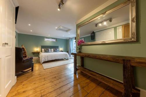 a bedroom with a bed and a large mirror at 58D Earlham Road in Norwich