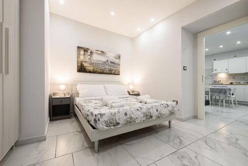 ein Schlafzimmer mit einem großen Bett in einem weißen Zimmer in der Unterkunft House giovy in Neapel