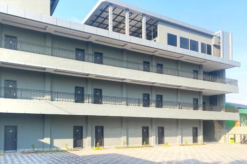 an external view of a building with a balcony at Urbanview Hotel AnD Lampung by RedDoorz in Lampung