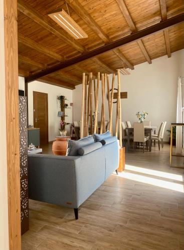 Una sala de estar con un sofá azul y una mesa. en Equiturismo San Lorenzo - Villa KAMARA, en Cammarata