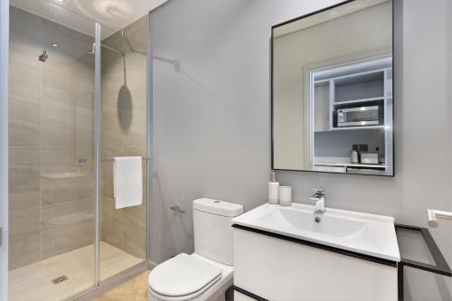 a bathroom with a toilet and a sink and a shower at One Thibault 2003 in Cape Town