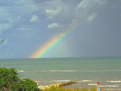 a rainbow in the sky over the ocean at Giardino delle Fate in Villa Rosa