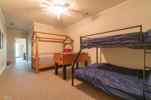 a bedroom with two bunk beds and a desk at Riverfront home within walking distance of Helen in Helen