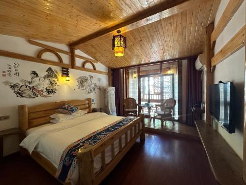 a bedroom with a bed and a tv in a room at Mountain View Guesthouse in Zhangjiajie
