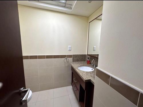 a bathroom with a sink and a mirror at Downtown Apartments with Fountain and Burj Khalifa View in Dubai