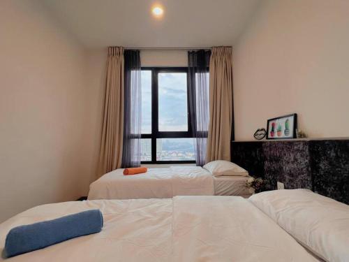 a bedroom with two beds and a window at 2 BR & 2 BTH with Free Parking @ Near ThemePark, SnowWalk & Central I-City Mall in Shah Alam