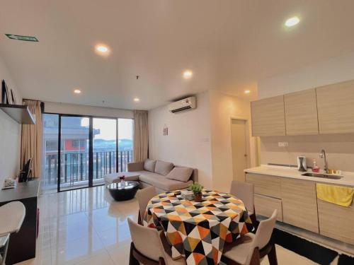 a kitchen and living room with a table and a couch at 2 BR & 2 BTH with Free Parking @ Near ThemePark, SnowWalk & Central I-City Mall in Shah Alam