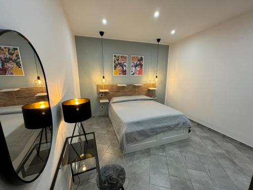 a bedroom with a bed and a mirror at Palermo Wow - Aragona in Palermo
