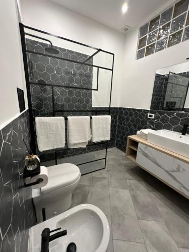 a bathroom with a toilet and a sink at Palermo Wow - Aragona in Palermo