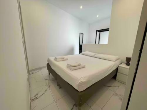a bedroom with a bed with two towels on it at Brooklyn Apartments Sliema in Sliema