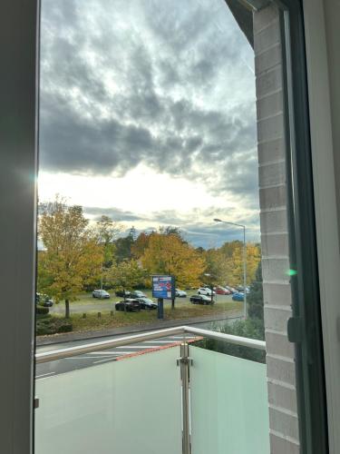 a window with a view of a parking lot at HAMA Design Homes Pader-Stars in Paderborn