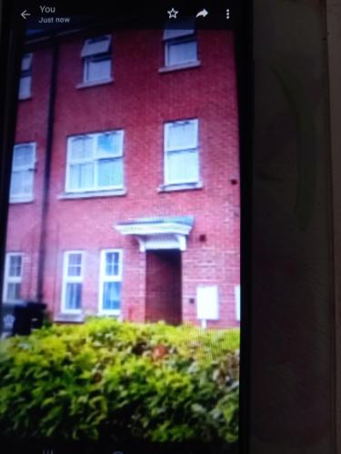 a large red brick building with a window at Private rooms, 2 showers in 3 storey hse, 25 minutes walk from Leicester city centre in Leicester