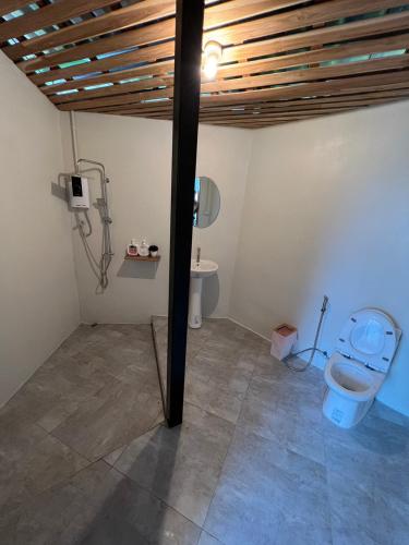 a bathroom with a toilet in a room at ริมว้าริว่า แคมป์ Rimwa Riwa Camp บ่อเกลือ น่าน in Ban Huai Mi