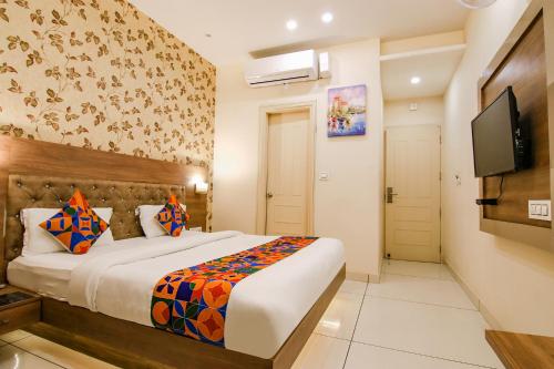 a bedroom with a bed and a flat screen tv at Hotel Florida -Manali Highway & 9 mins drive from Chandigarh University in Kharar