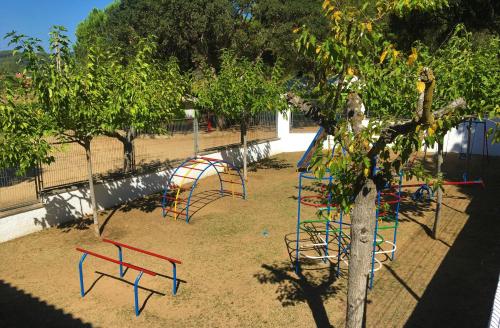 a playground with colorful equipment in a park at Cozy Glamping Chalet in Palams with Garden View in Palamós