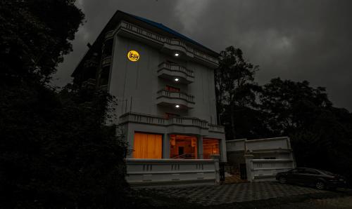 a building with a clock on the side of it at Itsy By Treebo -Classiyo Munnar Crown Resorts in Munnar
