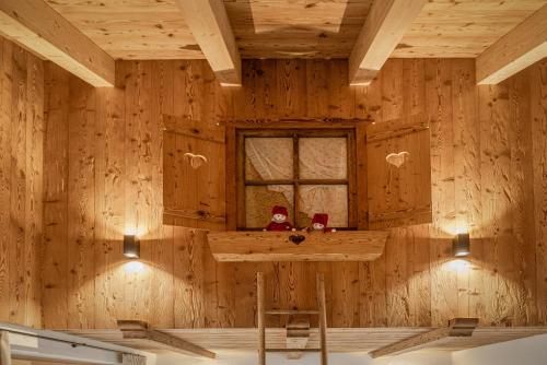 a room with a wooden wall with a bar in it at FARM CHALET JUSCIARA in Badia