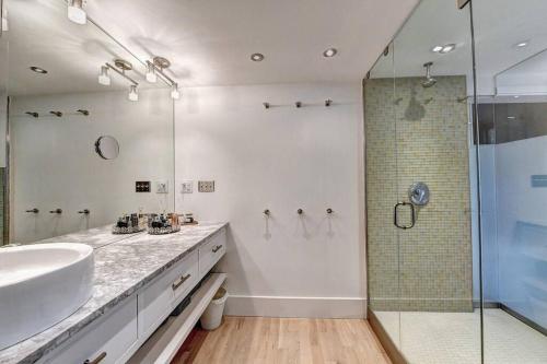 a white bathroom with a sink and a shower at Modern Farm house in heart of the City- Sleeps 8 in Atlanta