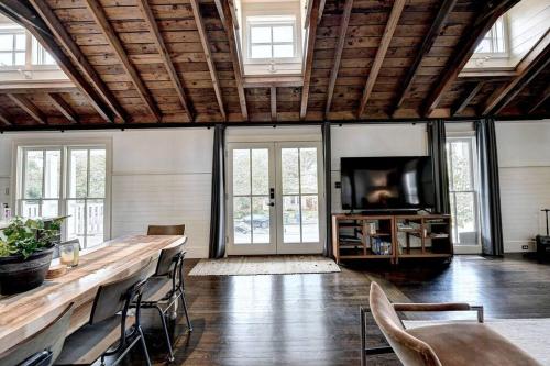 a living room with a table and chairs and a tv at Modern Farm house in heart of the City- Sleeps 12 in Atlanta