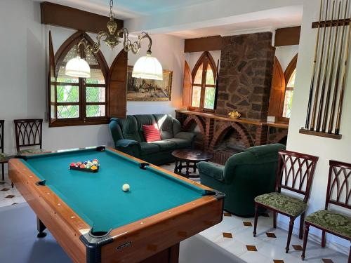 a living room with a pool table and a fireplace at Alojamiento Rural La Moraleja in Villanueva del Arzobispo