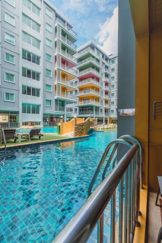 a swimming pool with buildings in the background at Elite Suites Patong in Patong Beach