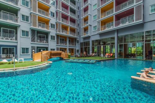 a swimming pool in the middle of a building at Elite Suites Patong in Patong Beach