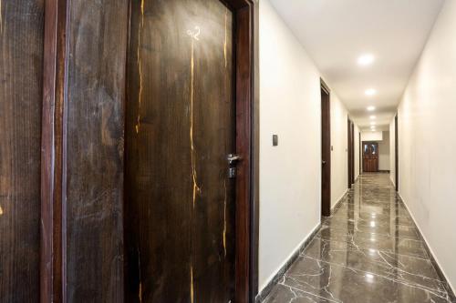 a hallway with a wooden door in a building at OYO Flagship Star Stay in New Delhi