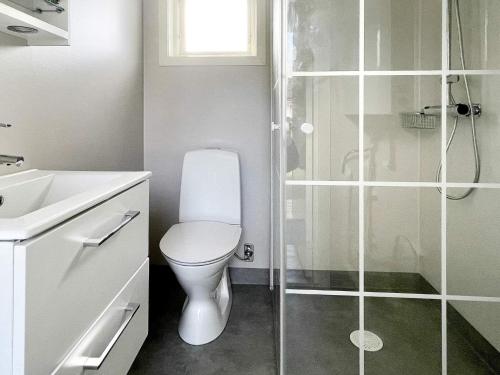 a white bathroom with a toilet and a shower at 7 person holiday home in Rockneby-By Traum in Rockneby