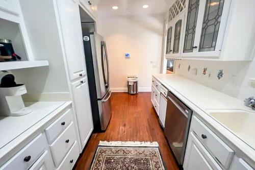 a kitchen with white cabinets and a refrigerator at Lookout Crest in Lookout Mountain