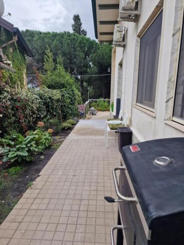 a patio with a table and chairs on a house at Althea Etna Garden in Nicolosi