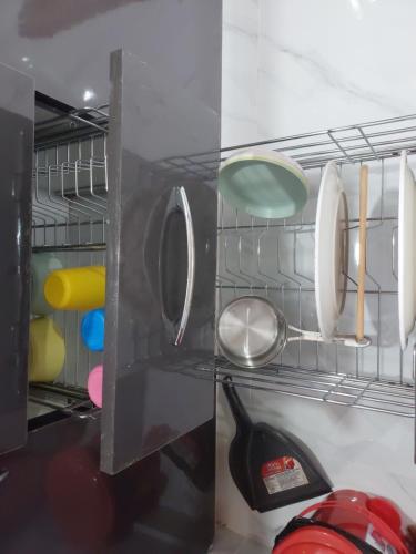 a shelf in a refrigerator with utensils at Deccan Stay in Hyderabad