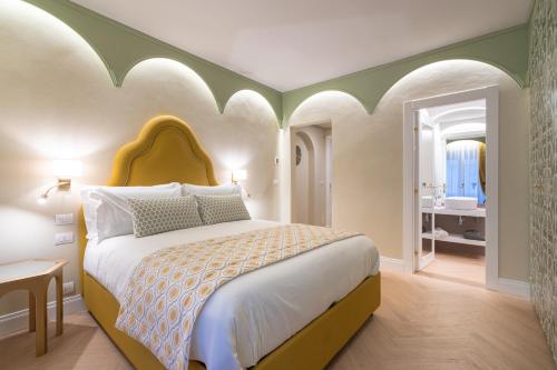 a bedroom with a large bed and a bathroom at La Dimora del Mercante in Florence