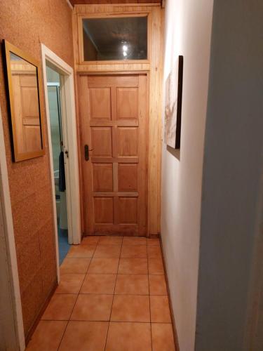 a hallway with a wooden door and a tile floor at Shady Glade in Hillcrest