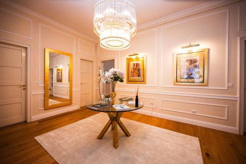 a dining room with a table and a chandelier at Luxury 3BDR Suite- Maison Imperial in Sarajevo