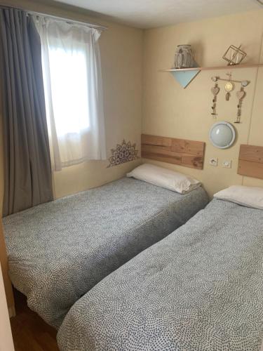2 camas individuales en un dormitorio con ventana en Nice little house, en Barcelona