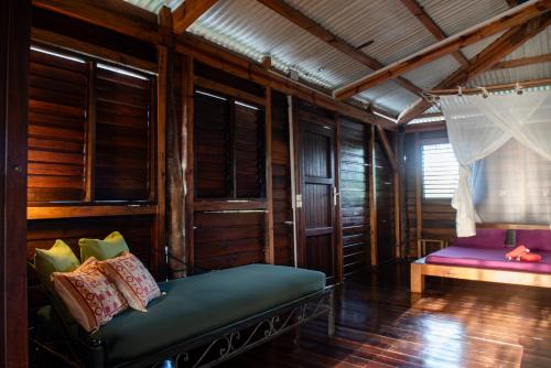 a living room with a couch and a window at Banana Moon in Ambatoloaka