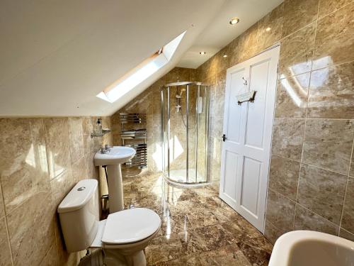 a bathroom with a toilet and a sink and a shower at Luxury Smugglers Cottage in the Heart of Inveraray Sleeps 4 in 2 Bedrooms in Inveraray